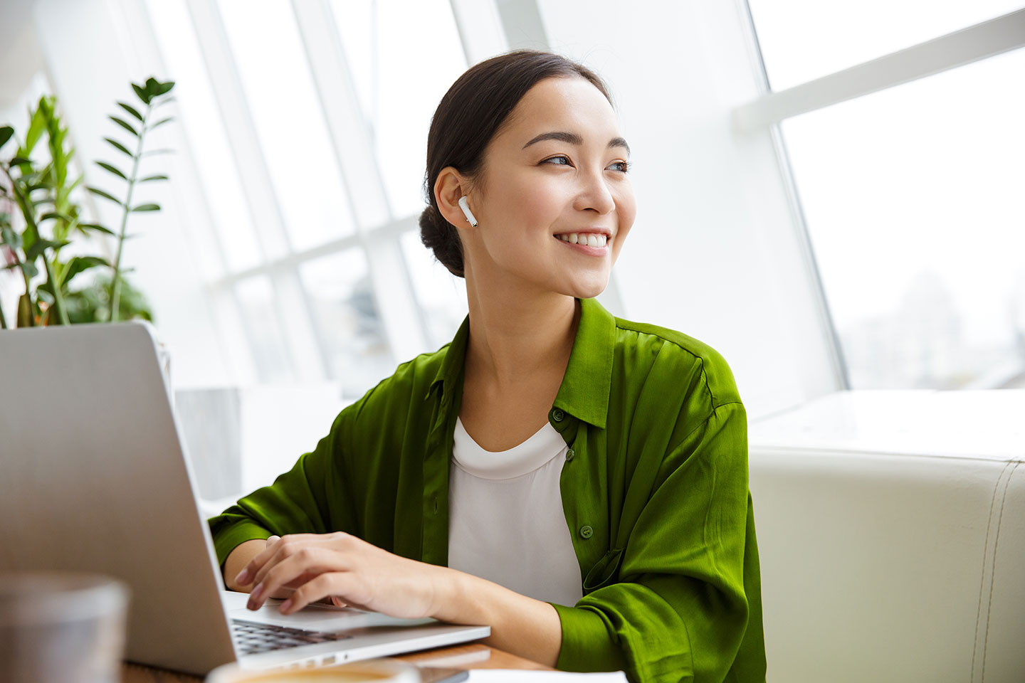 Professional female CPA looks out office hi-rise window